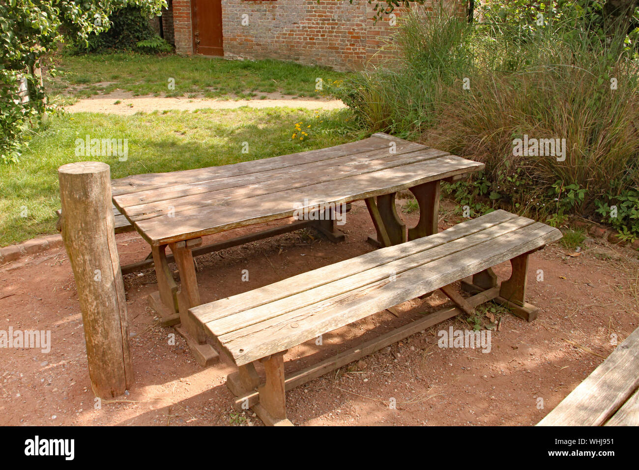 A Rustic Picnic Table And Bench In A Playground Stock Photo
