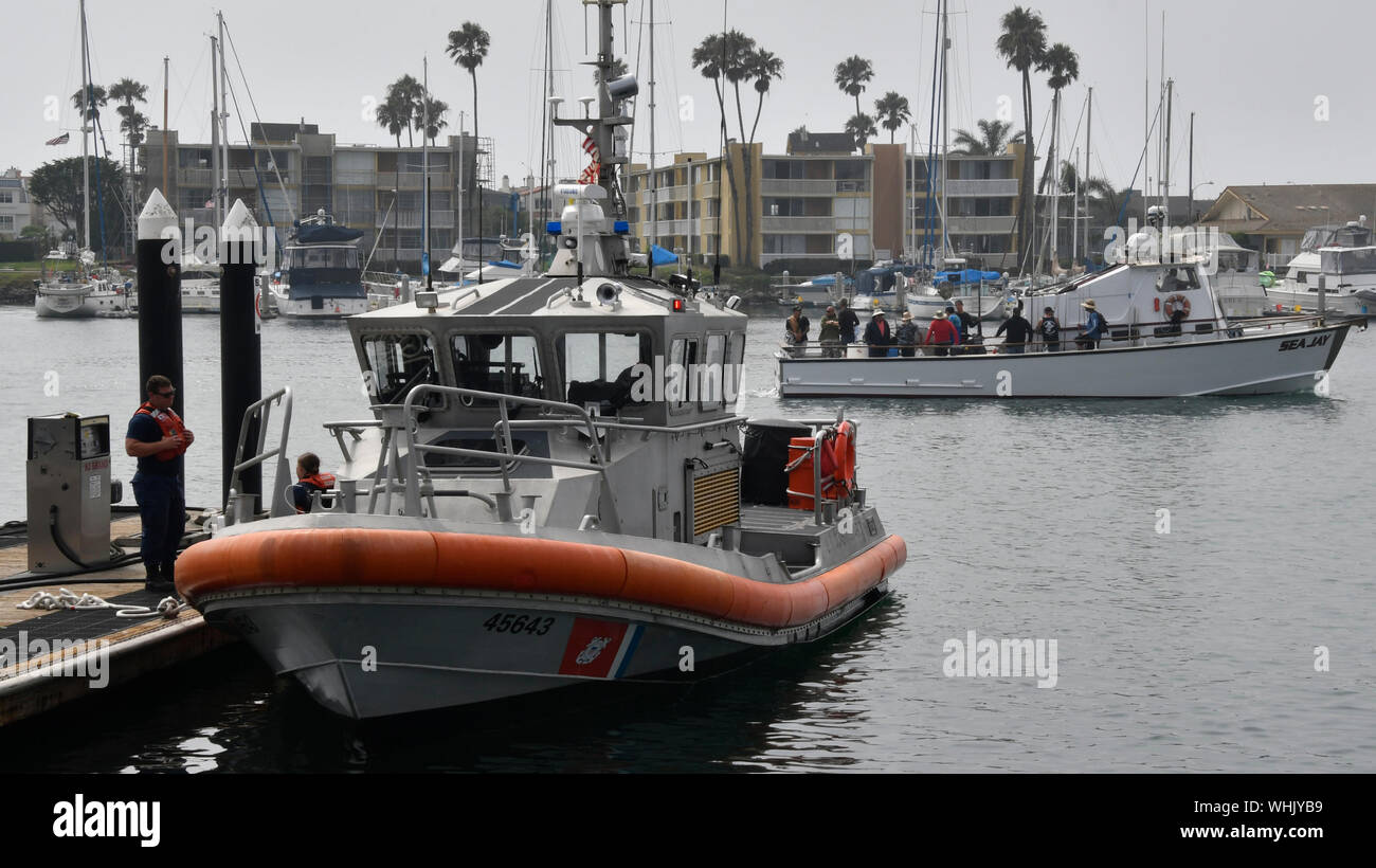 A fishing boat passes by one of the U.S. Coast Guard patrol boats as it comes in t refuel from the screen were five people were rescued and four bodies were recovered after a boat erupted in flames off the coast of Ventura County early Monday morning, prompting an ongoing search operation for more than two dozen people who remained missing, authorities said.The 75-foot Conception was anchored about 20 yards off Santa Cruz Island when the scuba diving vessel caught fire about 3:15 a.m., said Mike Eliason, a spokesman for the Santa Barbara County Fire Department.Multiple agencies responded t Stock Photo
