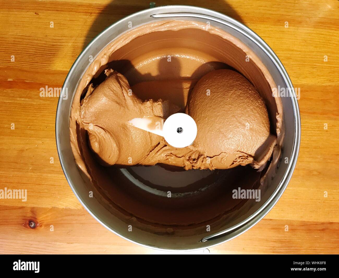 Directly Above Shot Of Chocolate Ice Cream In Maker On Table Stock Photo