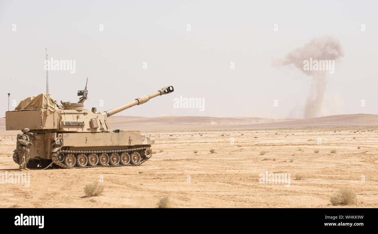 U.S. Army soldiers assigned to Alpha Battery, 3rd Battalion, 29th Field Artillery Regiment, 4th Infantry Division, fire a M109A6 Paladin in support of the joint training exercise Eager Lion ’19 at Training Area 1, Jordan, Aug. 27, 2019. Eager Lion, U.S. Central Command’s largest and most complex exercise, is an opportunity to integrate forces in a multilateral environment, operate in realistic terrain, and strengthen military-to-military relationships. Stock Photo