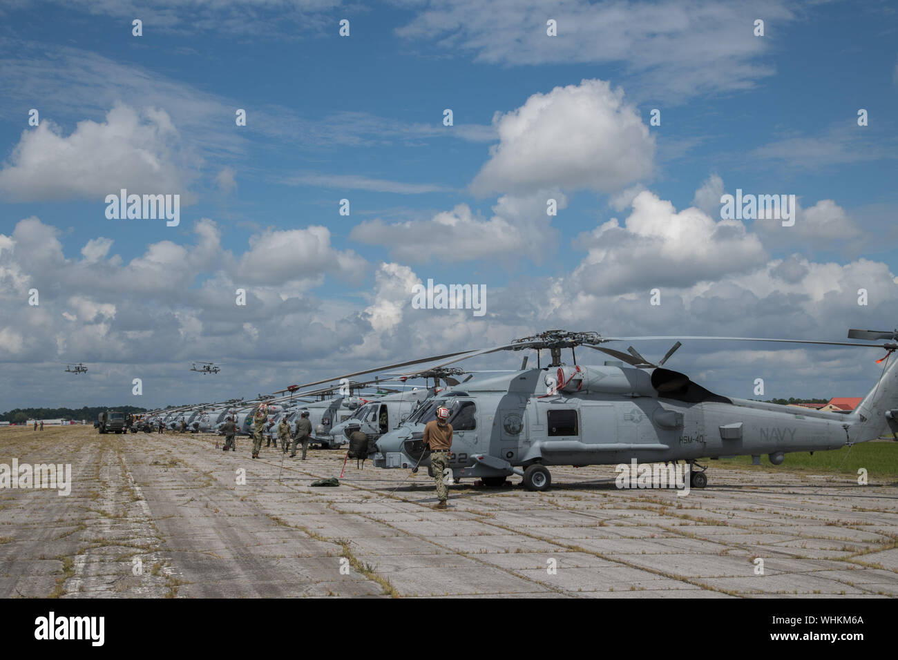 Sailors secure U.S. Navy MH60R Sea Hawk helicopters after arriving at Maxwell Air Force Base