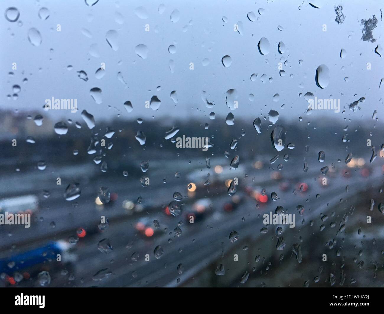Vehicles On Road Seen Through Wet Glass Window During Rainy Season ...