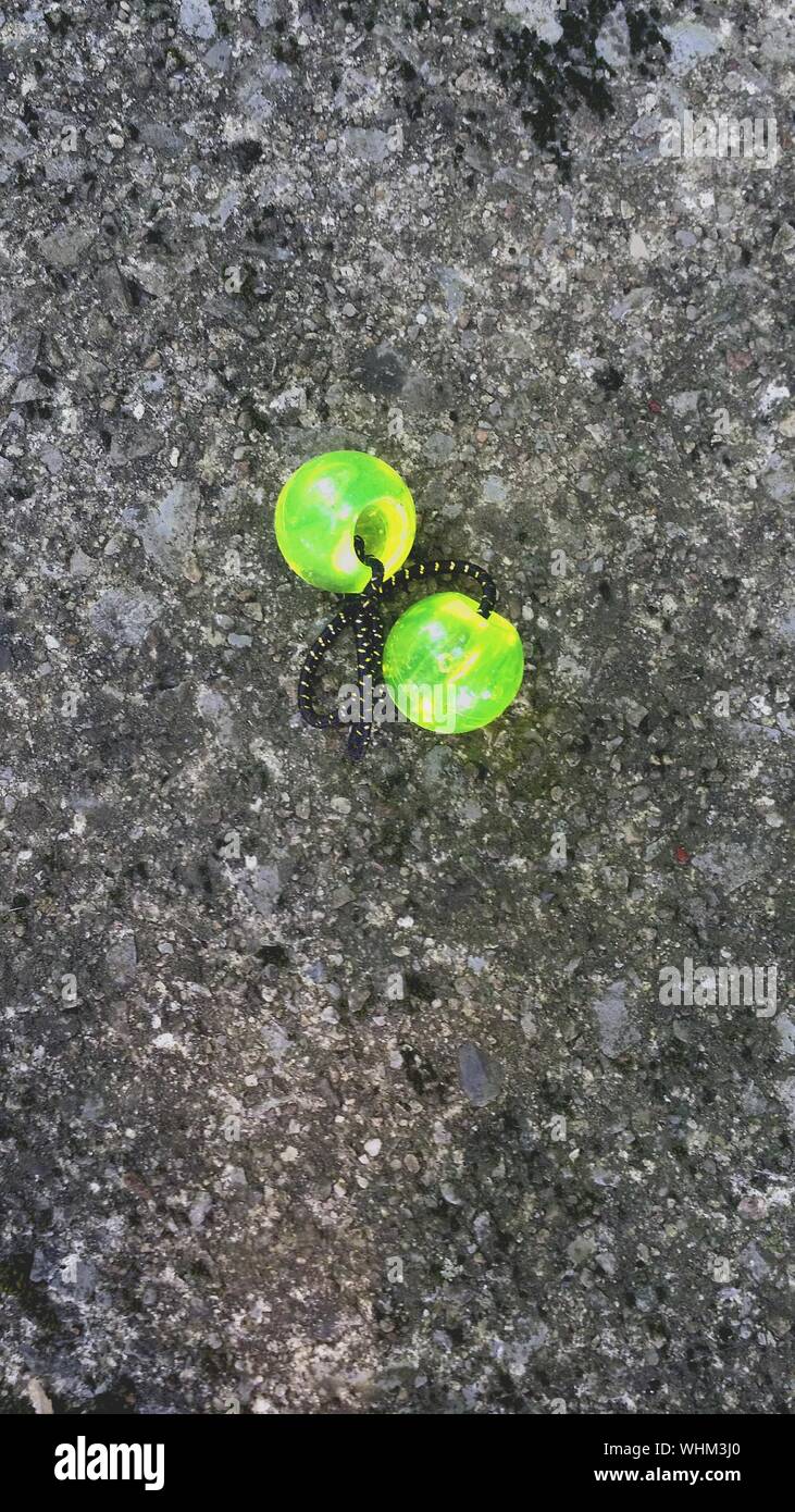 High Angle View Of Green Scrunchie On Road Stock Photo