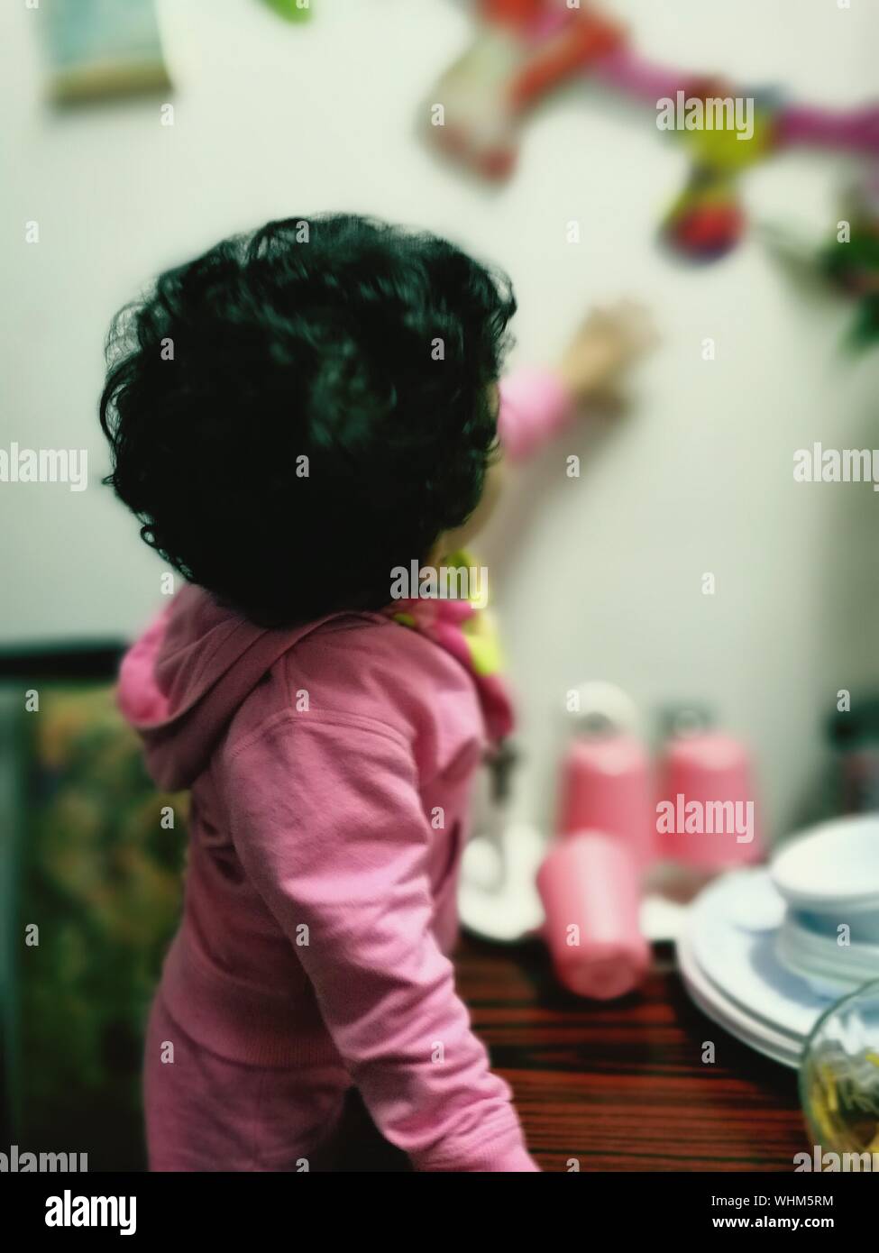 Side View Of Girl Touching Wall At Home Stock Photo Alamy