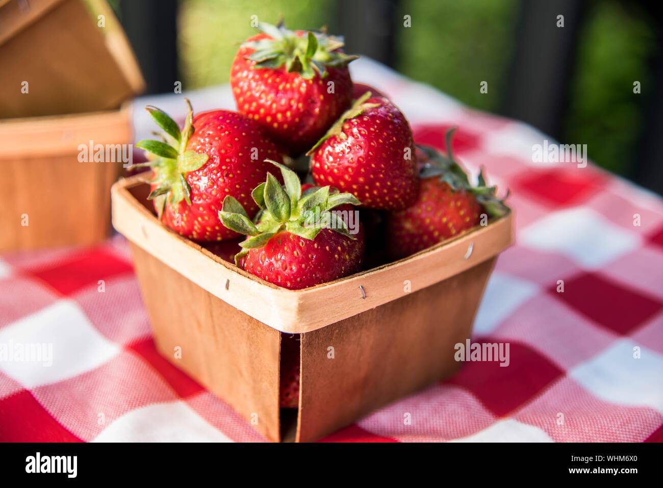Close-up Of Fresh Strawberries In Wooden Basket On Table Stock Photo