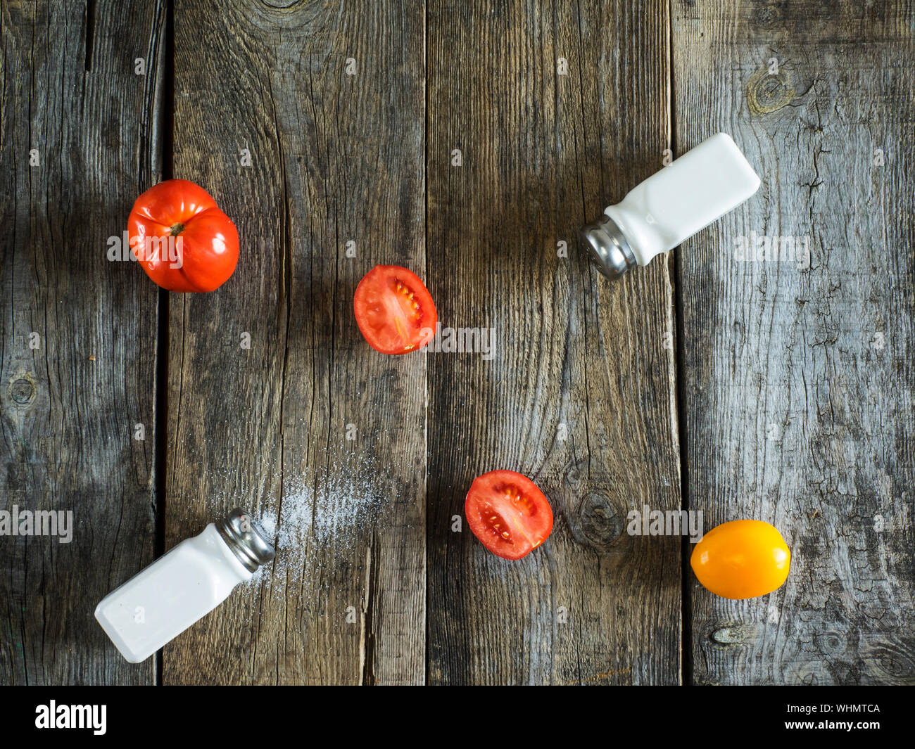 Directly Above View Of Shakers With Tomatoes On Wooden Table Stock Photo