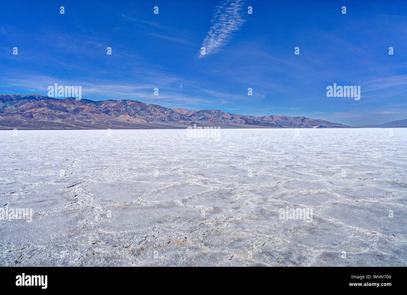 View Of Badwater Basin At Death Valley National Park Against Blue Sky Stock Photo