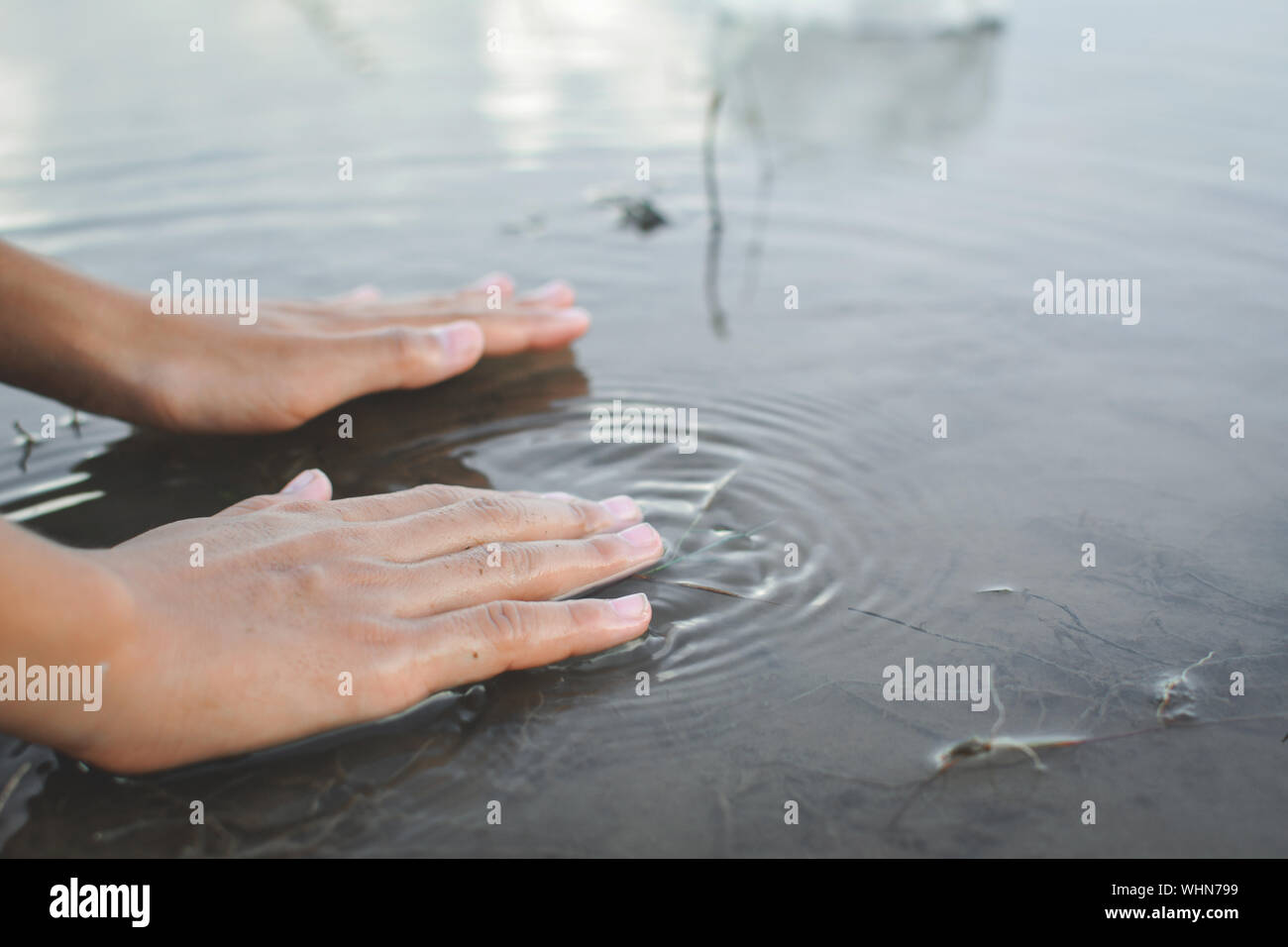 Hands Of A Woman Above Water Stock Photo