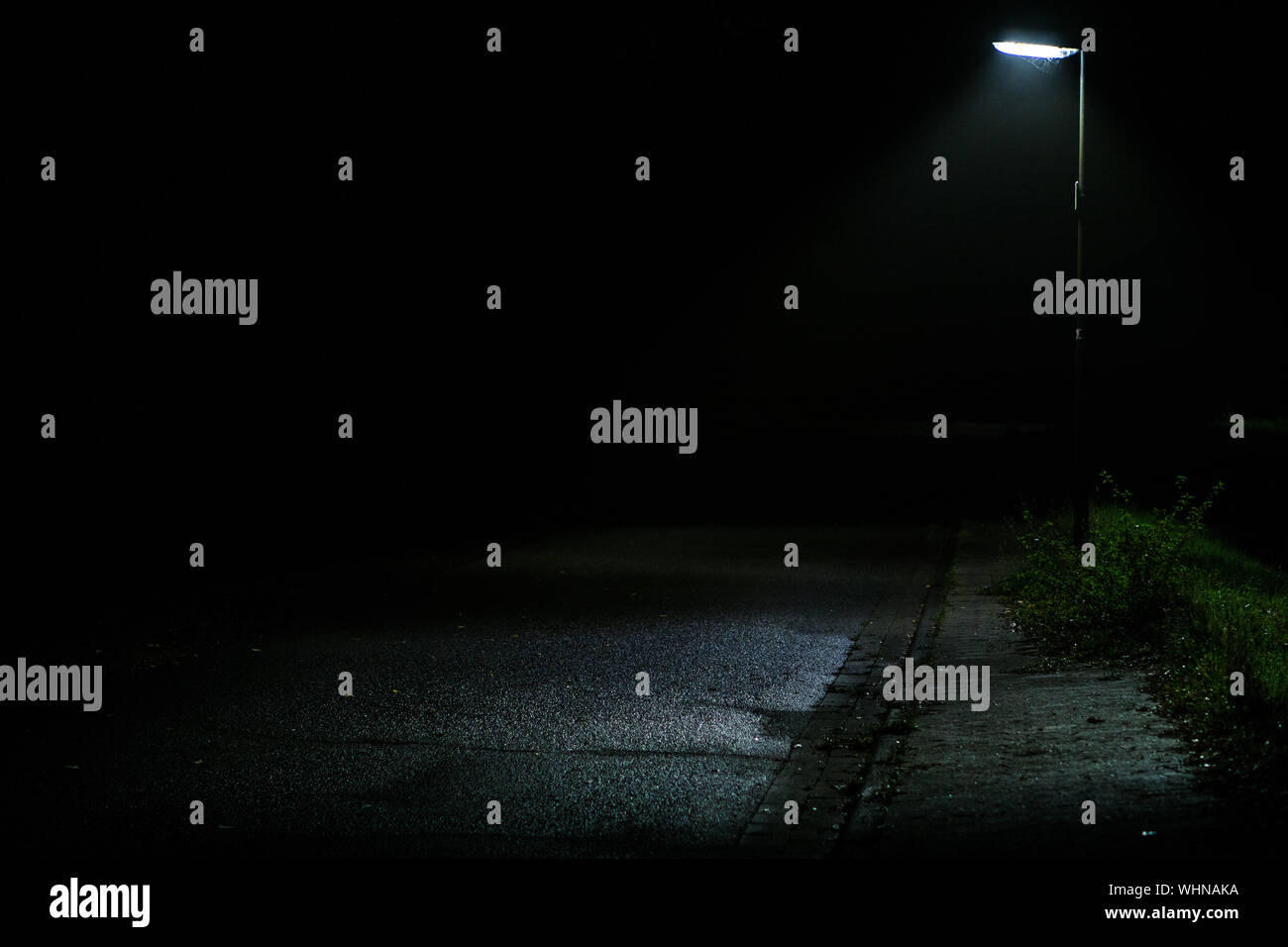 Empty Road By Illuminated Street Light At Night Stock Photo - Alamy