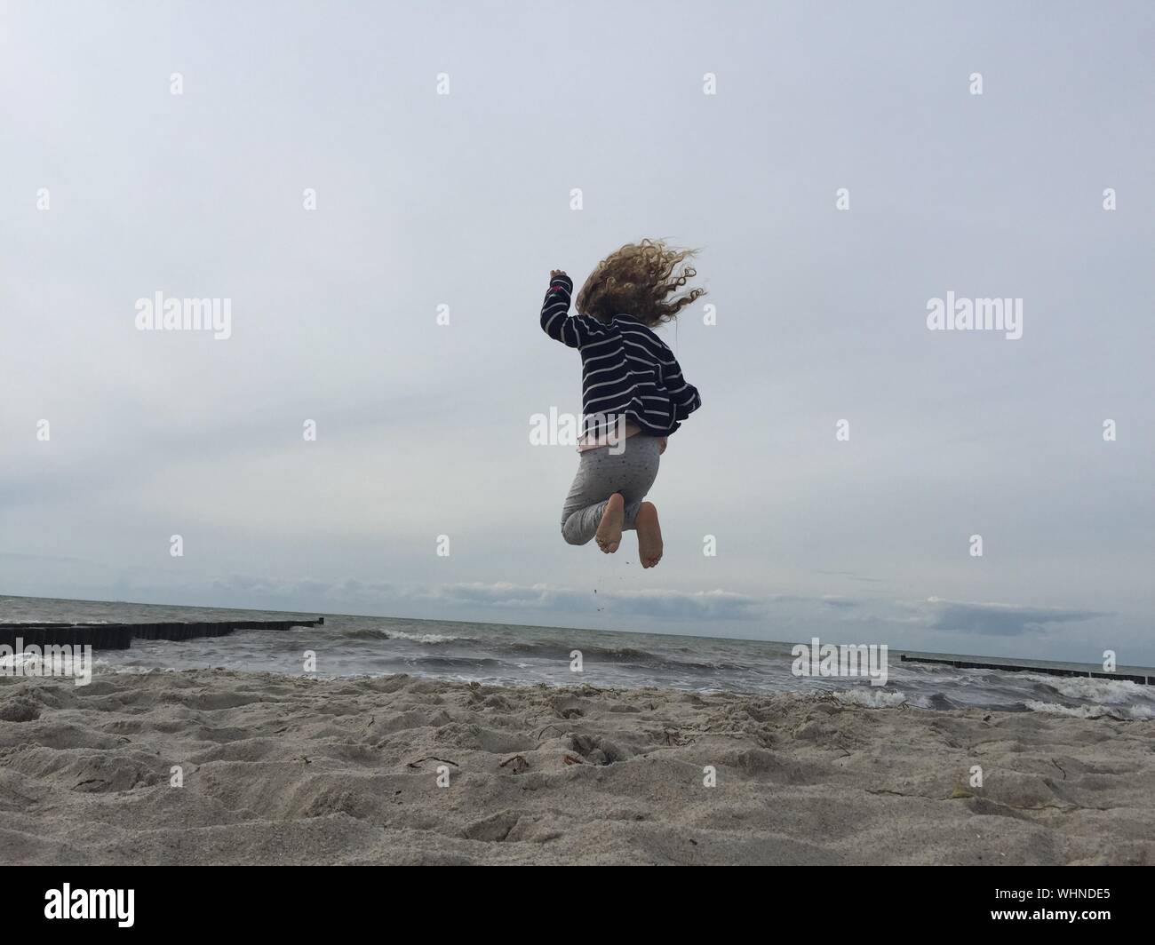 Girl jumping in water rear hi-res stock photography and images - Alamy