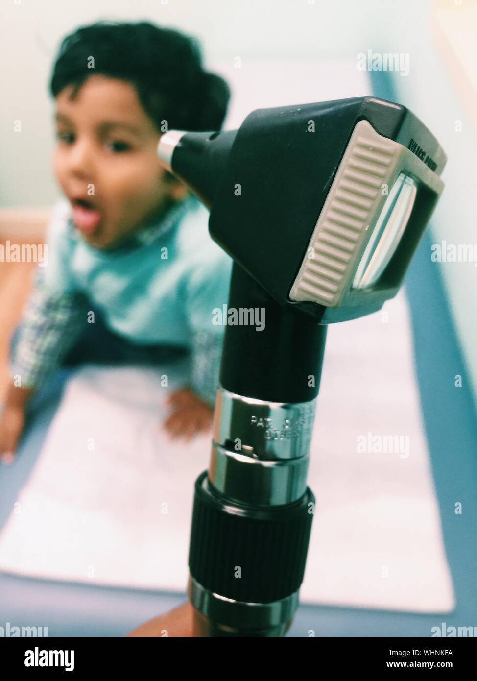 Close-up Of Medical Instrument With Boy In Background Stock Photo