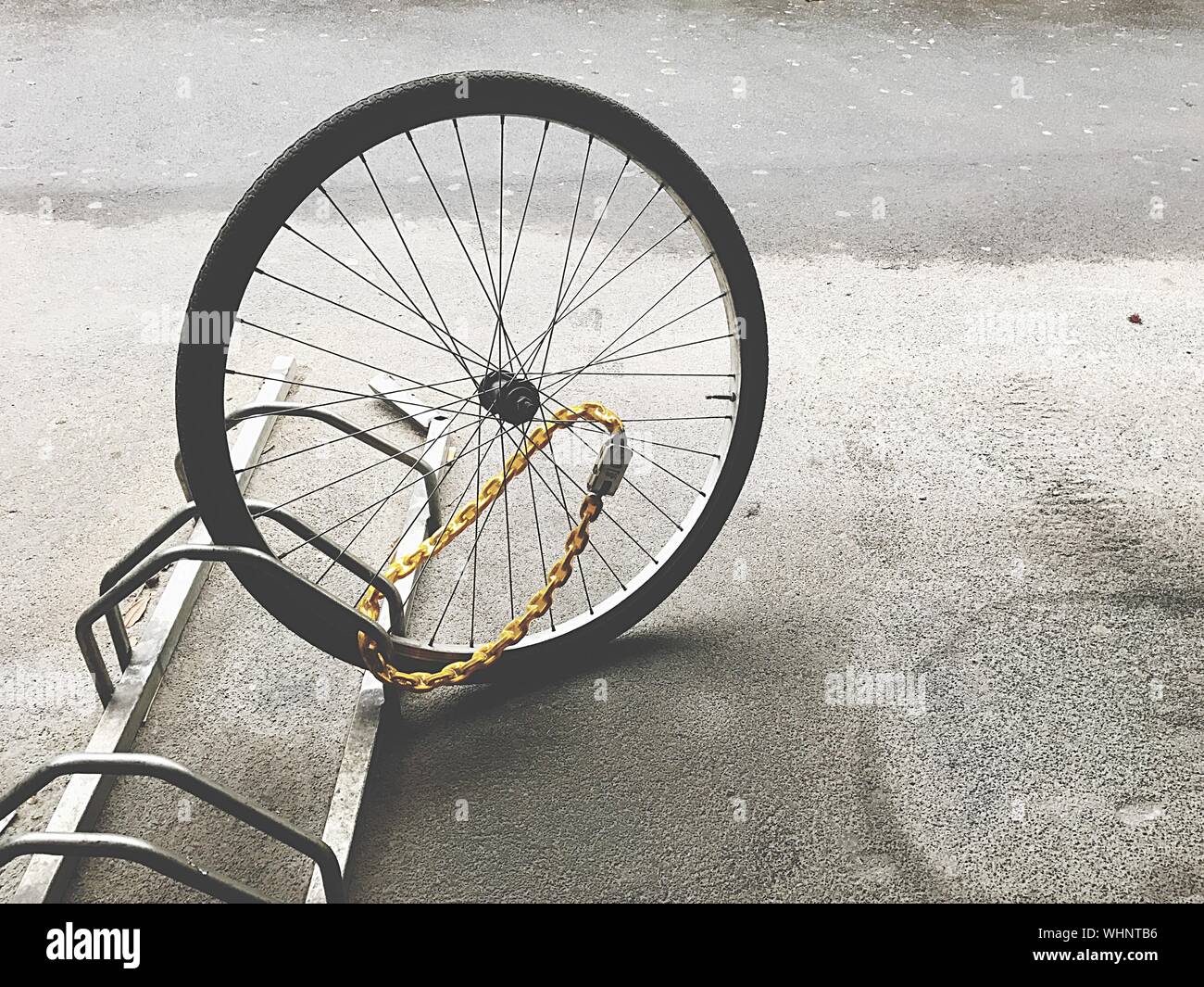 Wheel Locked To Bicycle Rack At Parking Lot Stock Photo Alamy