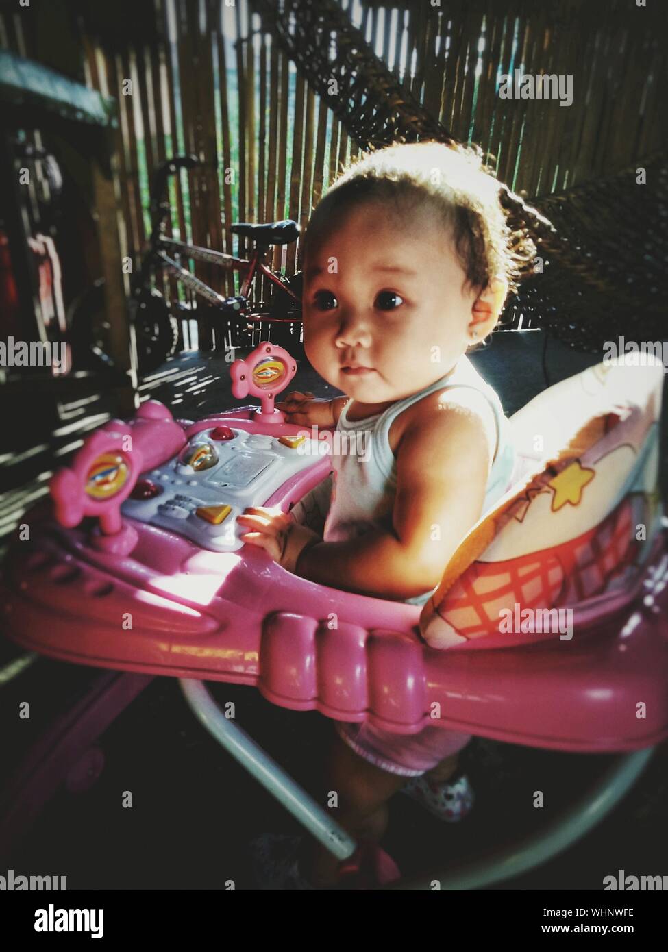 Close Up Of Cute Baby Girl In Baby Walker Stock Photo Alamy