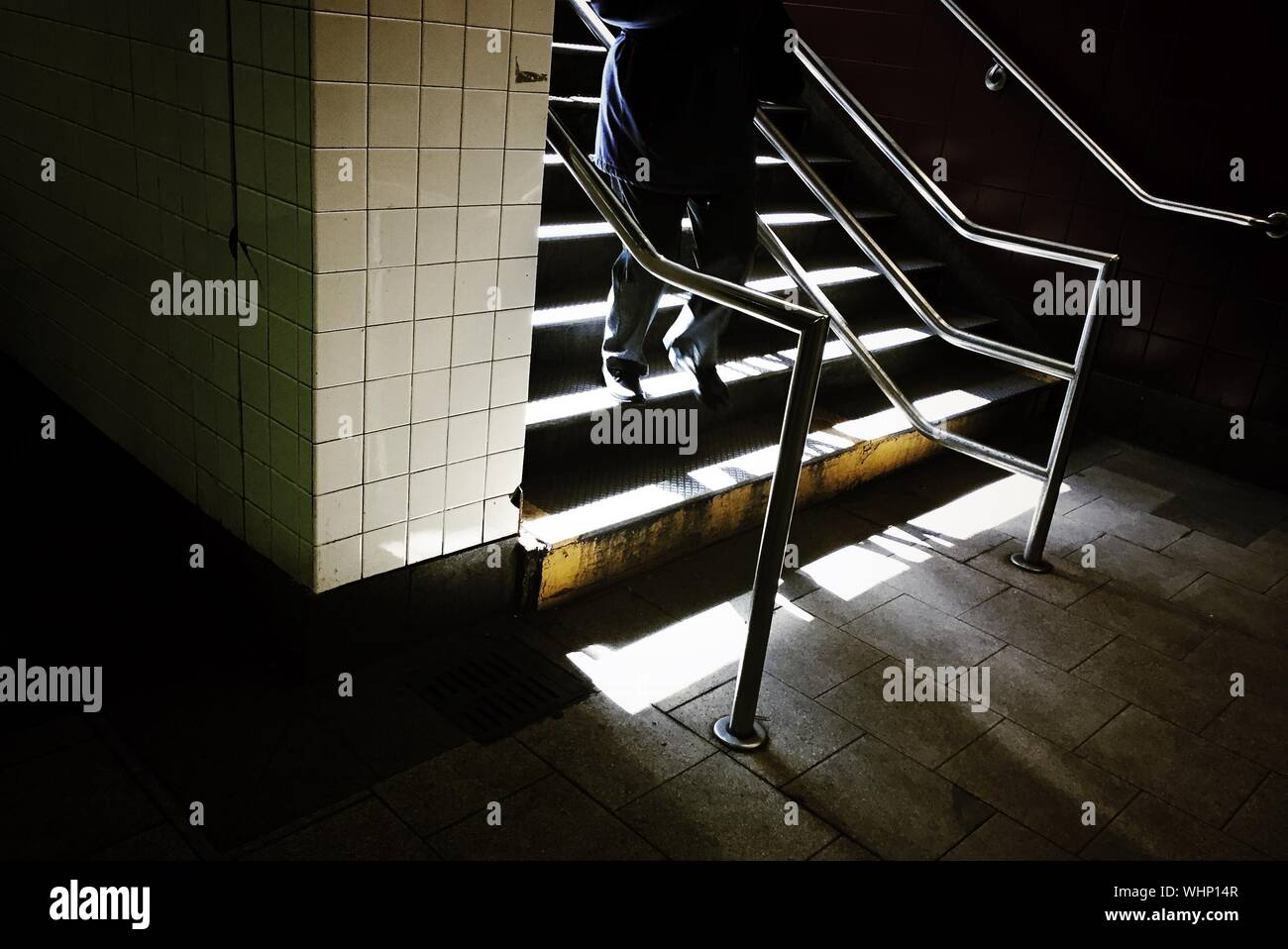 Person Moving Downstairs At Subway Stock Photo