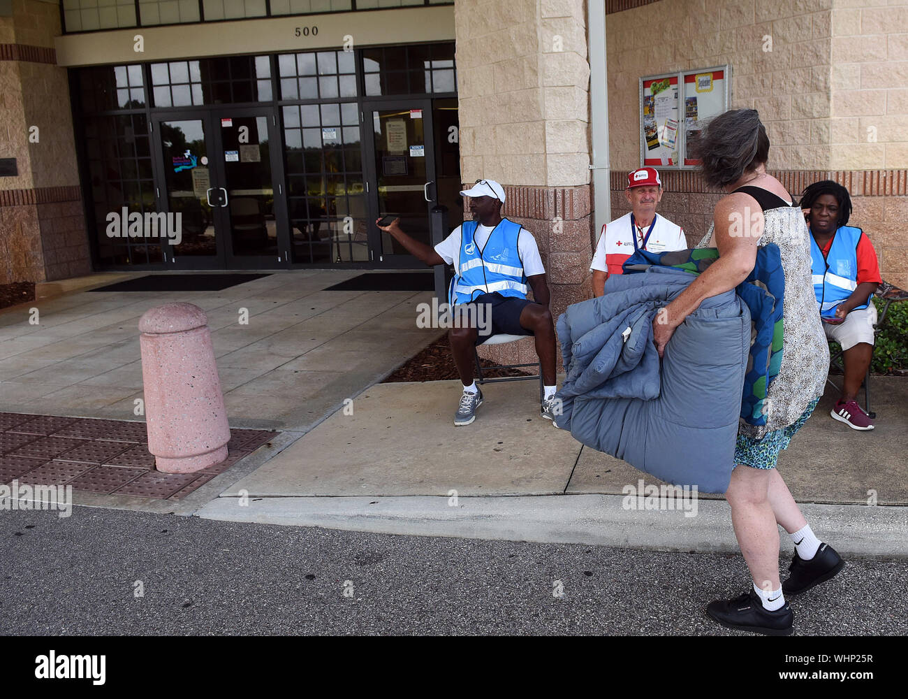 September 2, 2019 - Cocoa, Florida, United States - A woman carrying blankets arrives at an evacuation shelter as Hurricane Dorian is forecast to move dangerously close to the coast to Florida after striking the Bahamas as a Category 5 storm, on September 2, 2019 in Cocoa, Florida. Credit: Paul Hennessy/Alamy Live News Stock Photo
