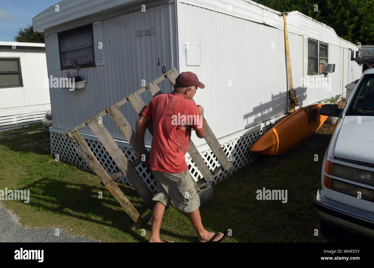 Cape Canaveral, United States. 02nd Sep, 2019. September 2, 2019 - Cape Canaveral, Florida, United States - A resident of the Cocoa Palms Mobile Home Park secures a wooden pallet in his yard before he evacuates as Hurricane Dorian is forecast to move dangerously close to the coast to Florida after striking the Bahamas as a Category 5 storm, on September 2, 2019 in Cape Canaveral, Florida. Credit: Paul Hennessy/Alamy Live News Stock Photo