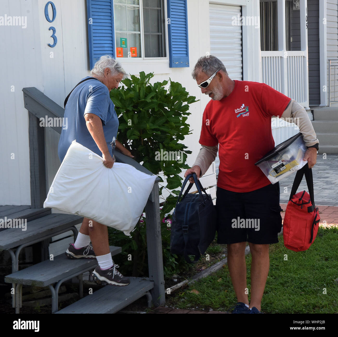 Cape Canaveral, United States. 02nd Sep, 2019. September 2, 2019 - Cape Canaveral, Florida, United States - Don Ingram helps Coleen Casey with her belongings as she leaves her mobile home for an evacuation shelter as Hurricane Dorian is forecast to move dangerously close to the coast to Florida after striking the Bahamas as a Category 5 storm, on September 2, 2019 in Cape Canaveral, Florida. Credit: Paul Hennessy/Alamy Live News Stock Photo