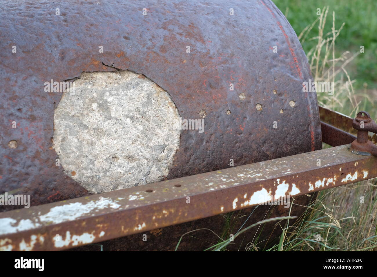 High Angle View Of Rusty Damaged Metallic Roller By Grass Stock Photo