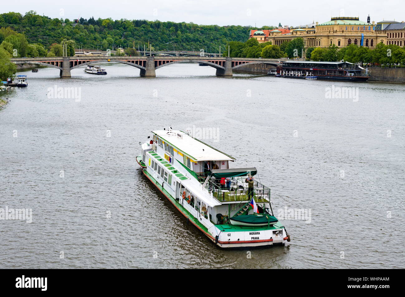 View of a tour boat on the Vltava River with the Mánes Bridge in the background, Prague, Czech Republic Stock Photo