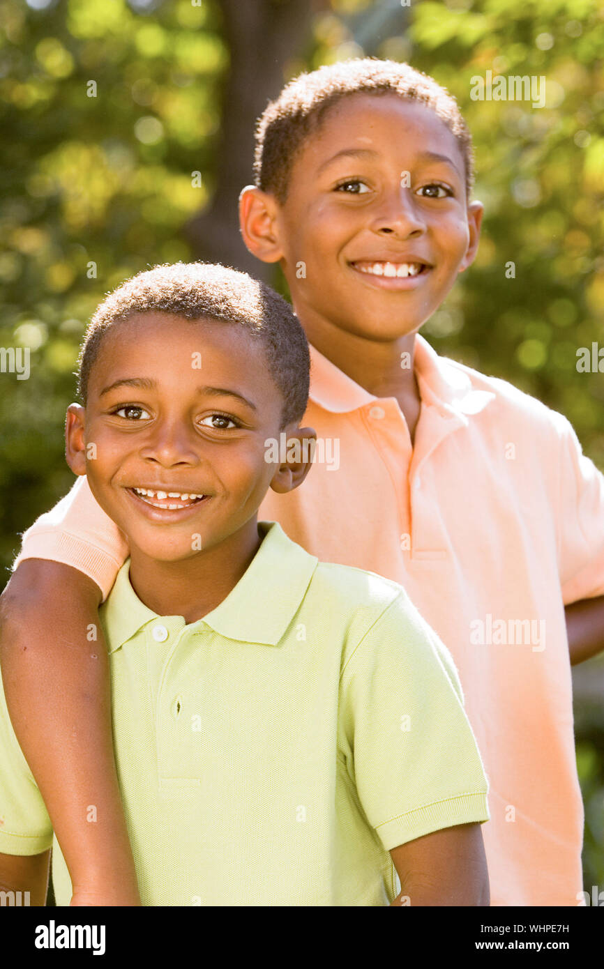 two African American brothers pose for a portrait outside Stock Photo