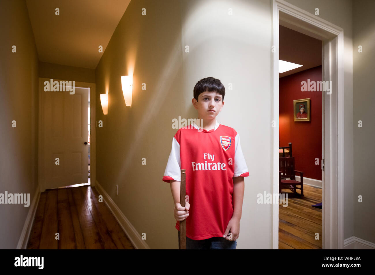 a young boy stands in the hallway of his home Stock Photo Alamy
