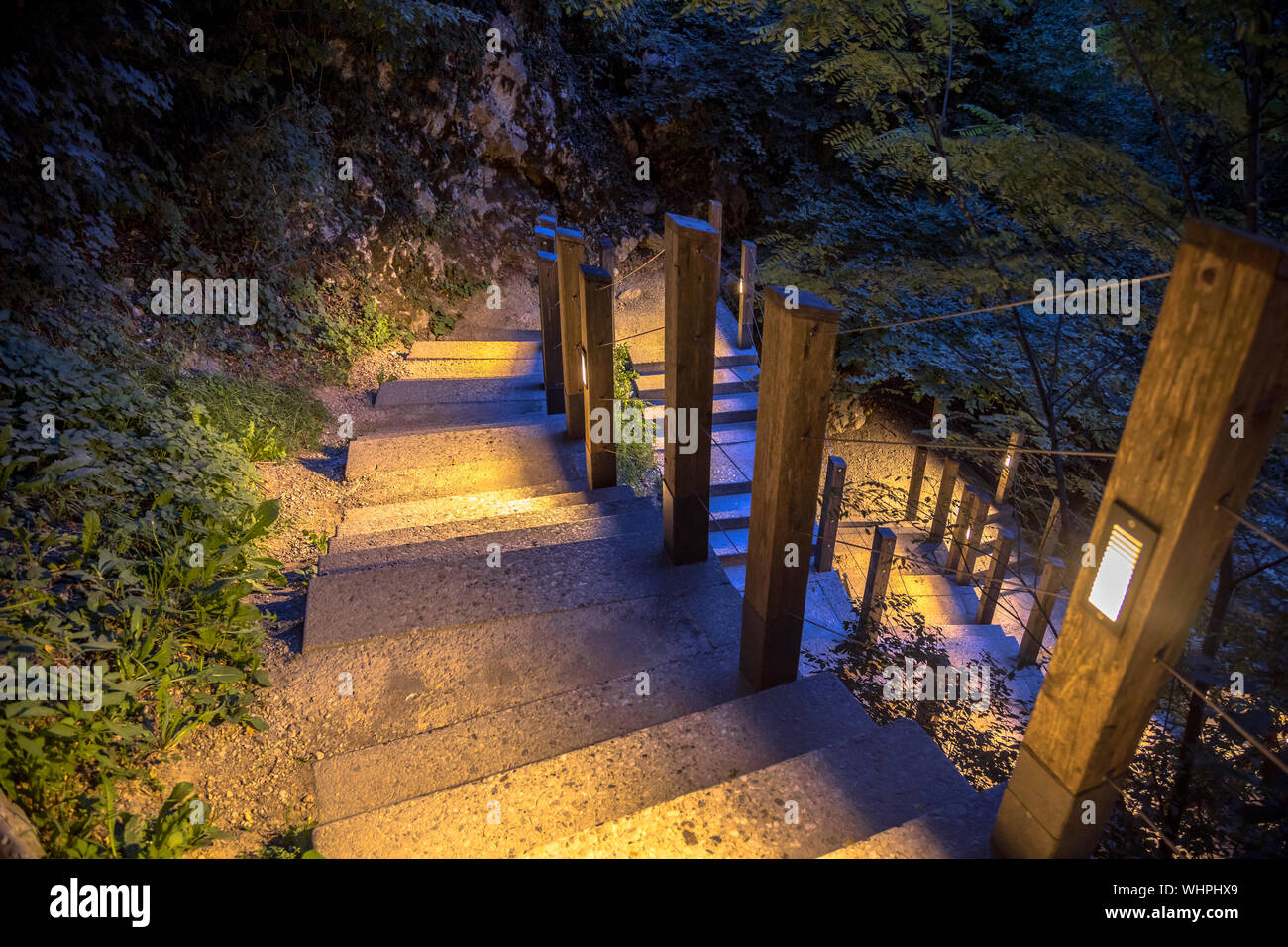 Illuminated outdoor Staircase down rocky mountain park at night Stock Photo
