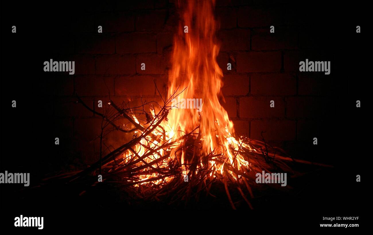 Close-up Of Fire Against Wall Stock Photo