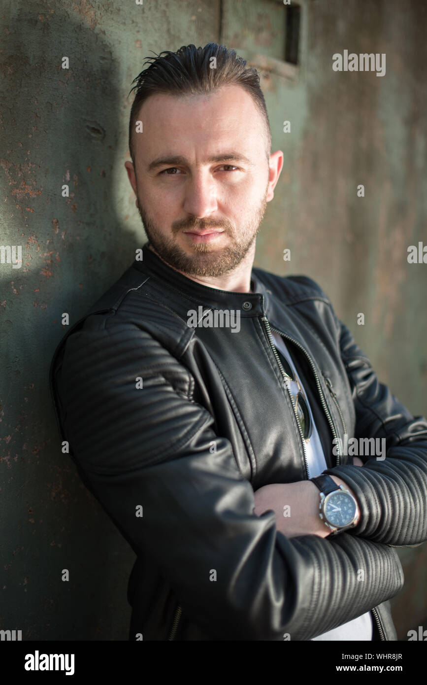 Man in leather jacket standing hi-res stock photography and images - Alamy