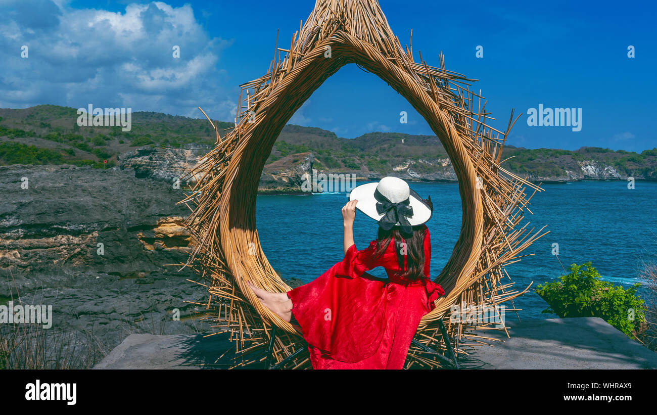 Woman sitting on straw nests in Bali island, Indonesia. Stock Photo