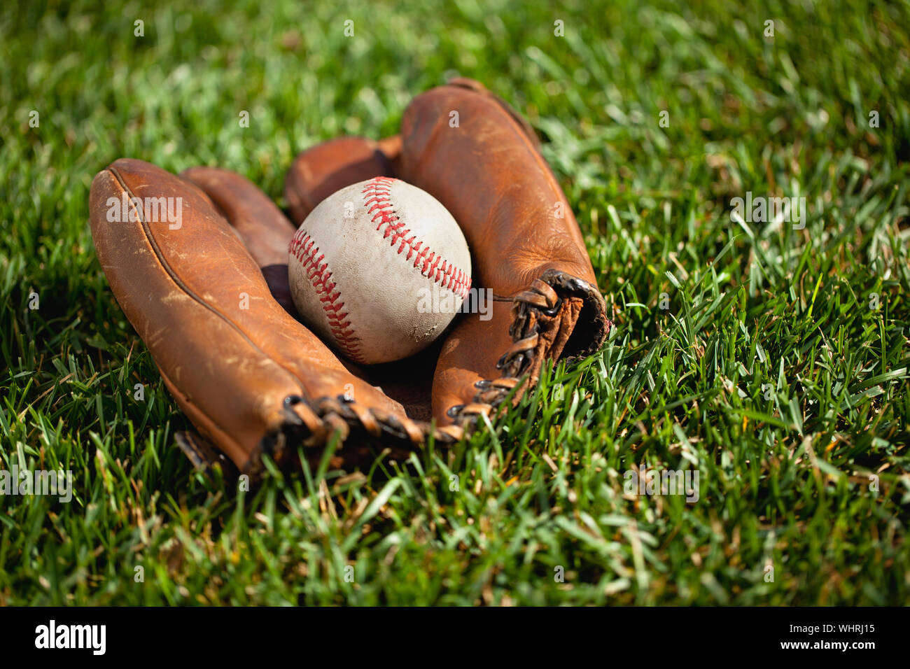Ball In Baseball Cap On Grass Stock Photo