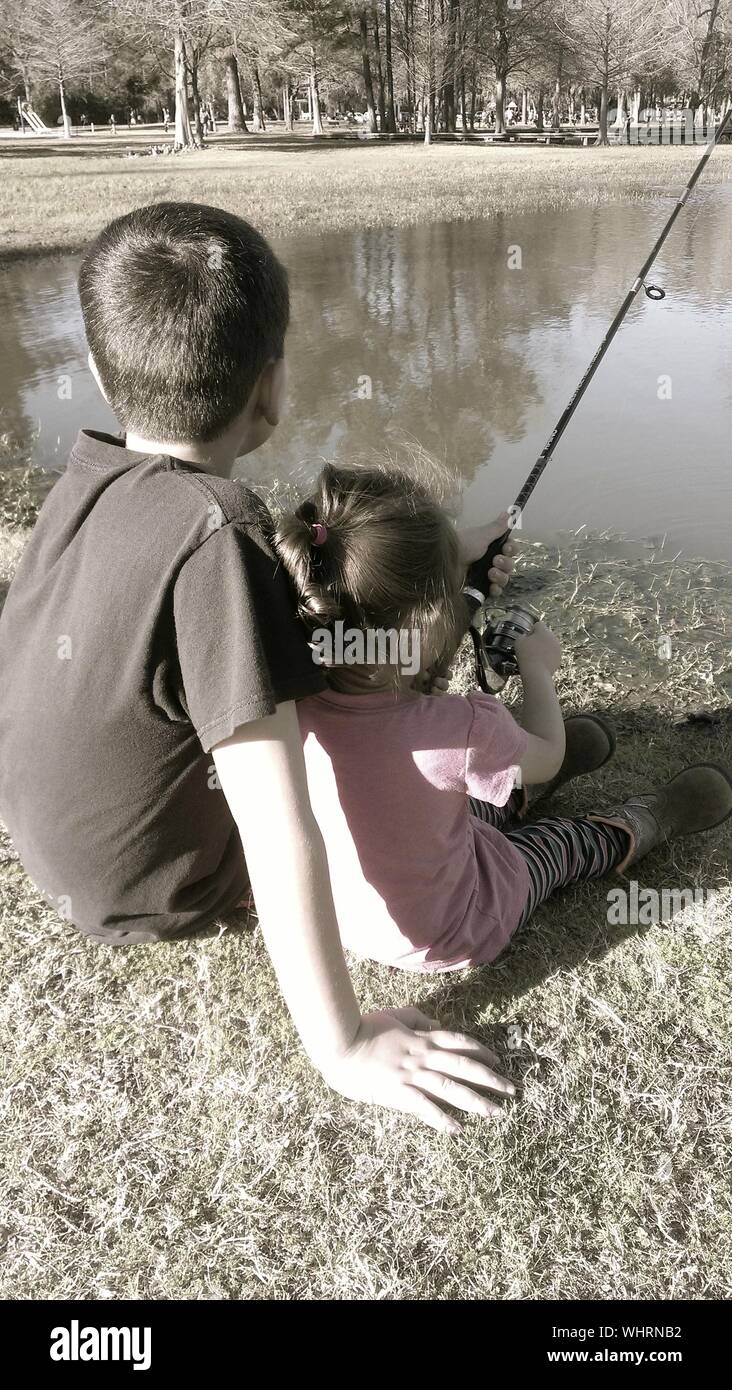 Two boys sitting fishing hi-res stock photography and images - Alamy