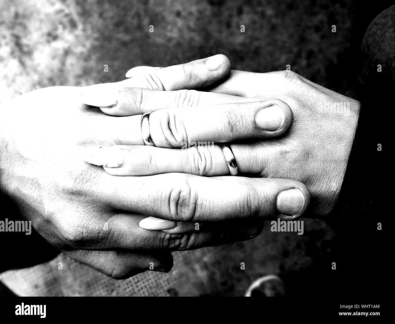 Two clasped hands holding Black and White Stock Photos & Images - Alamy