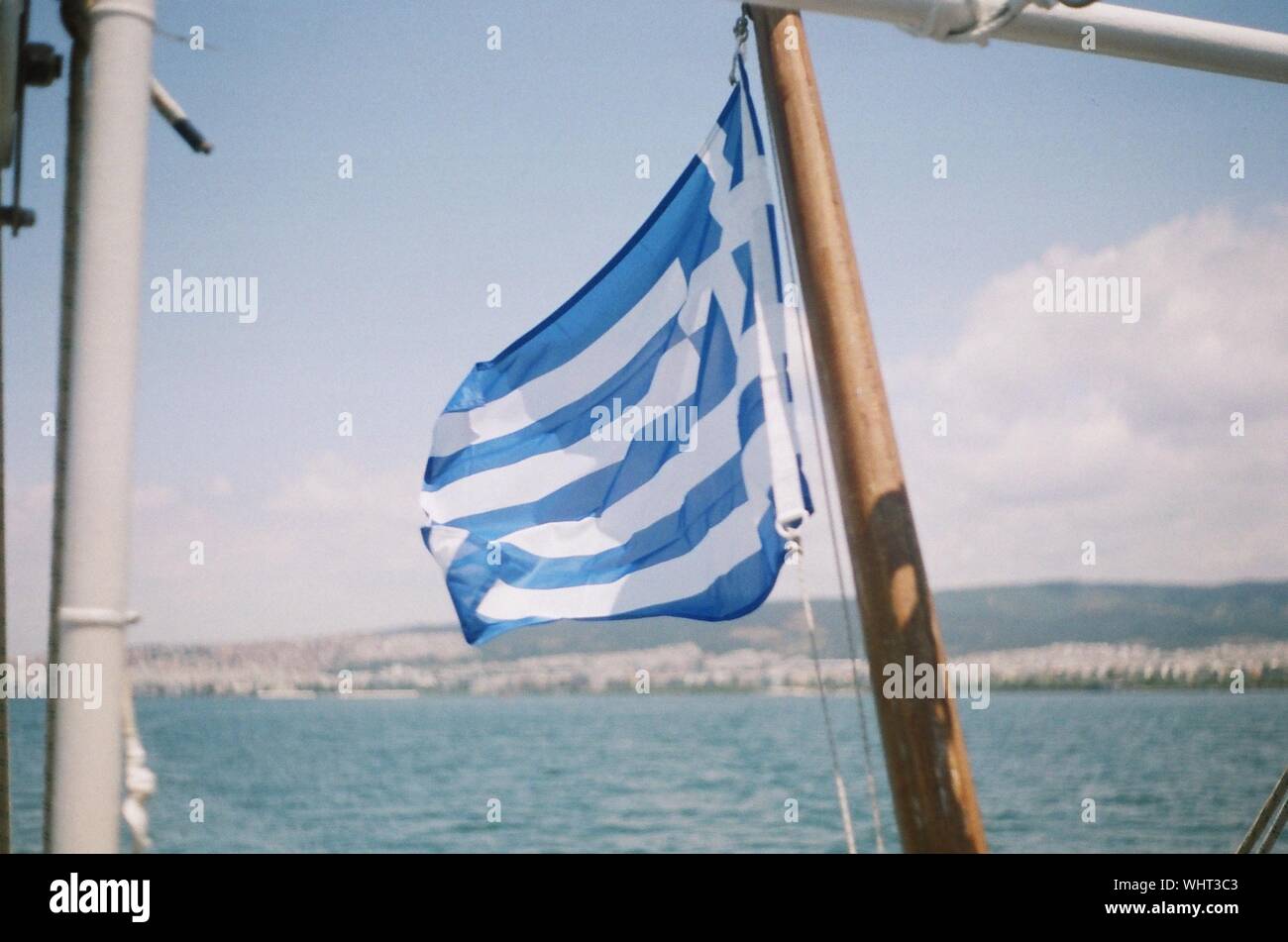 Greece Flag By Sea Against Sky Stock Photo