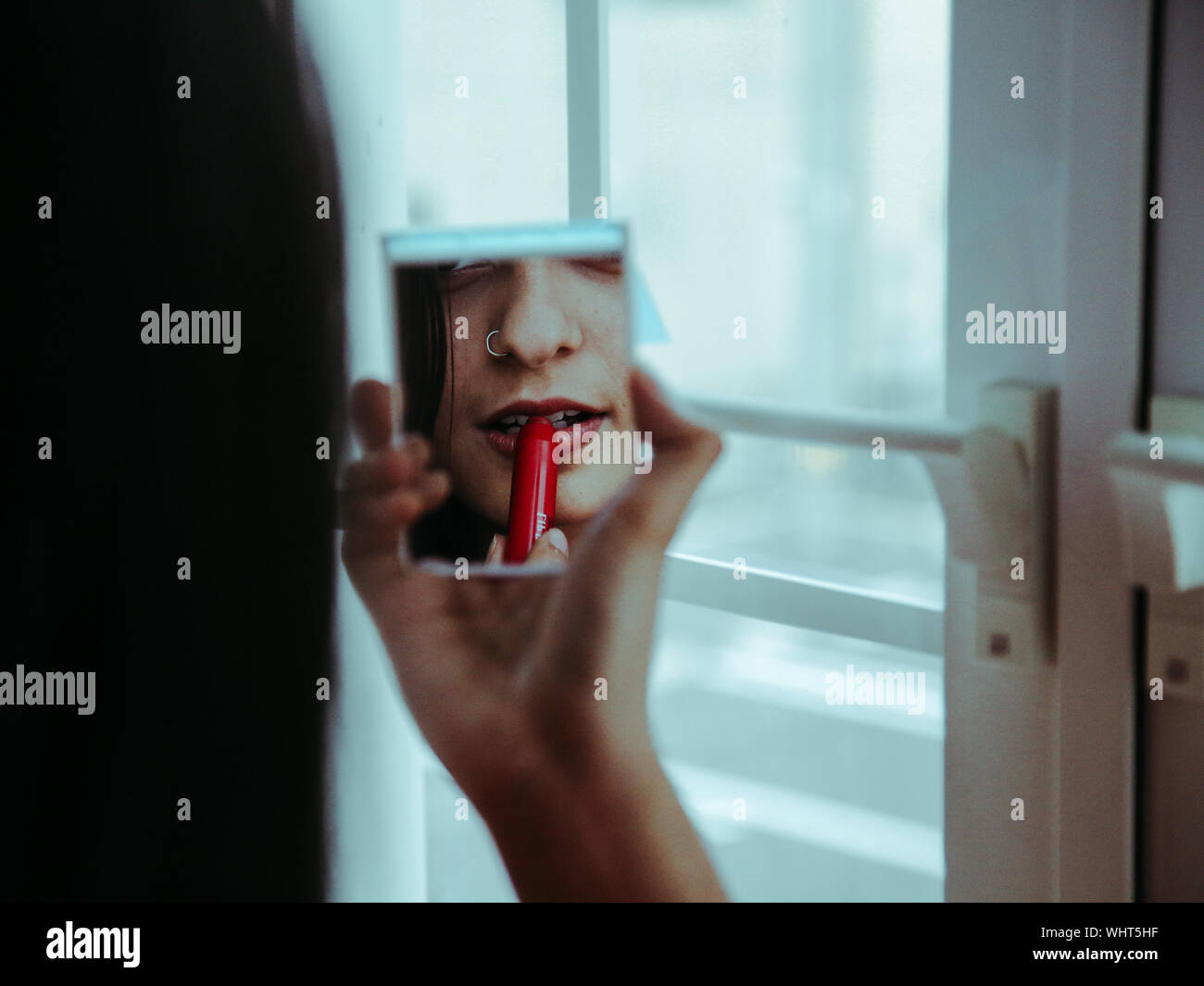 Hand holding lipstick mirror hi-res stock photography and images - Alamy