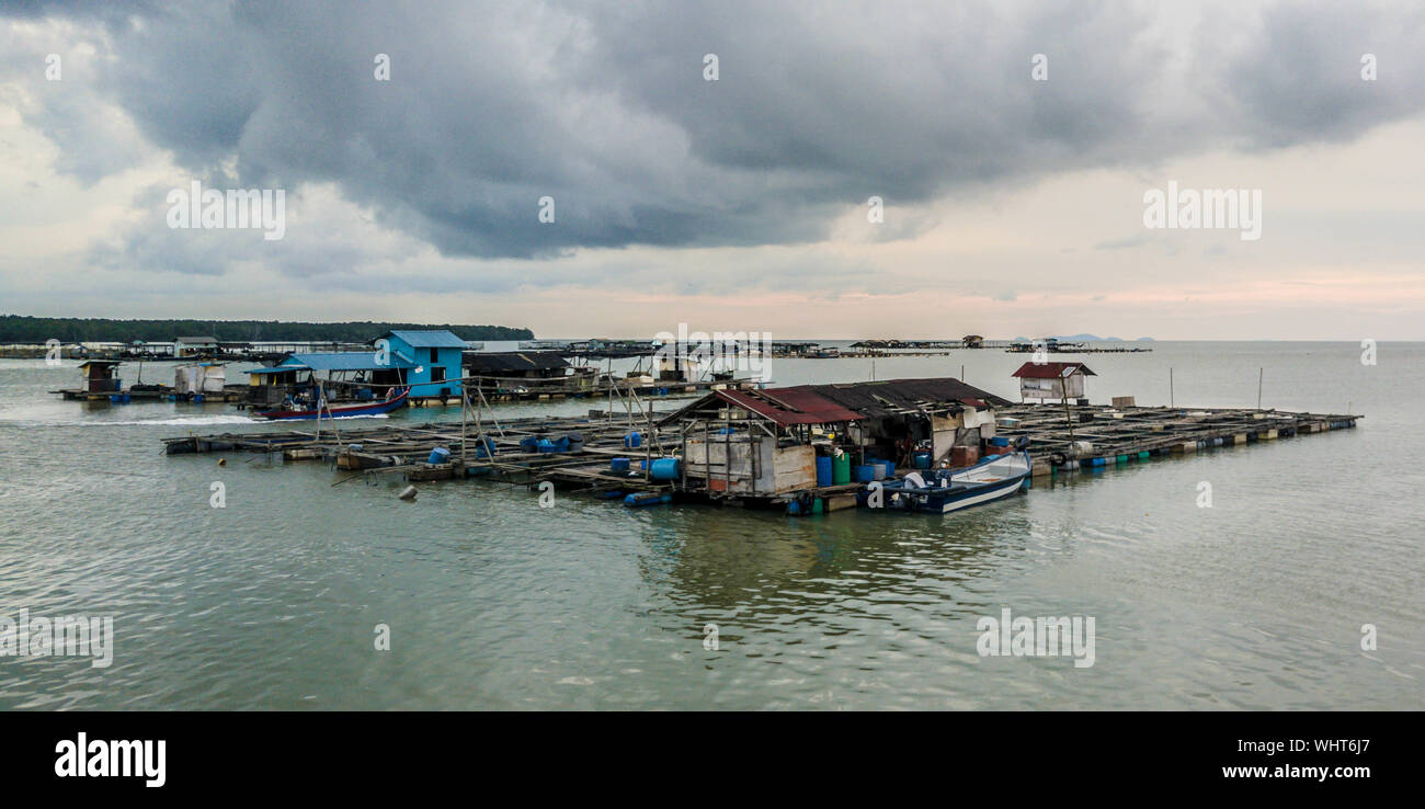 Fish Farm On Sea Against Cloudy Sky During Sunset Stock Photo
