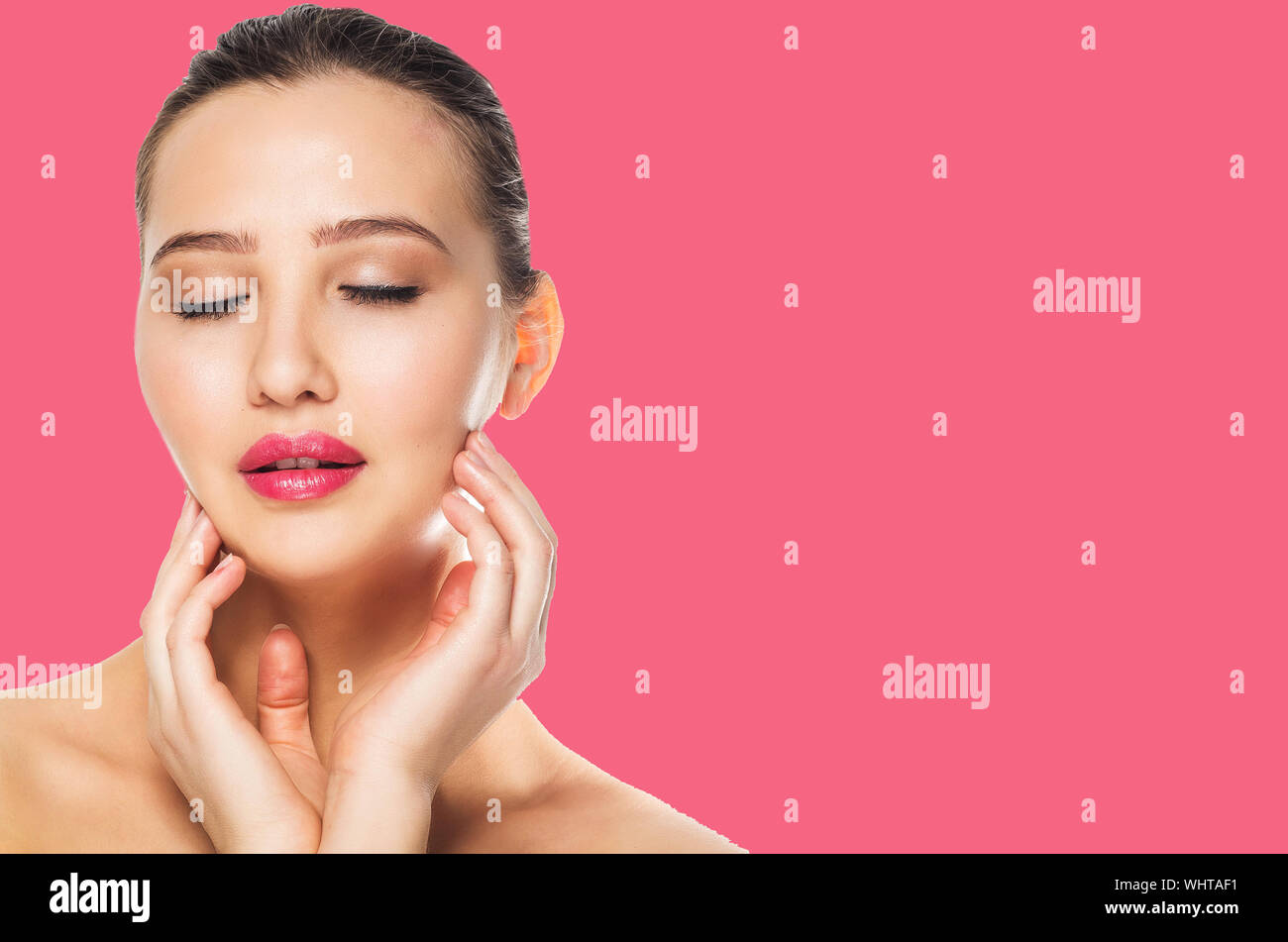 Portrait of beautiful girl touching her face on pink background, close ...