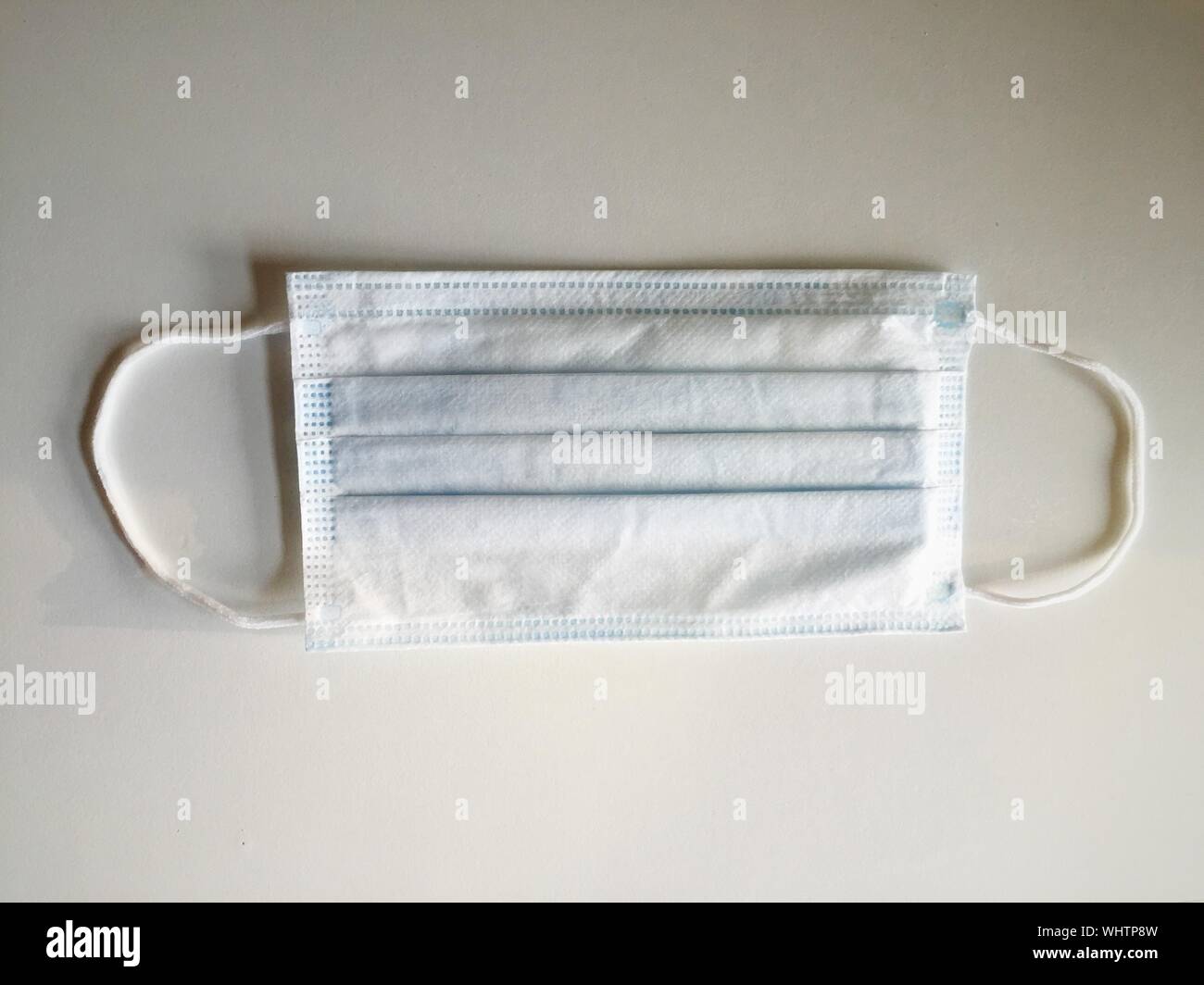Directly Above View Of Surgical Mask On White Background Stock Photo
