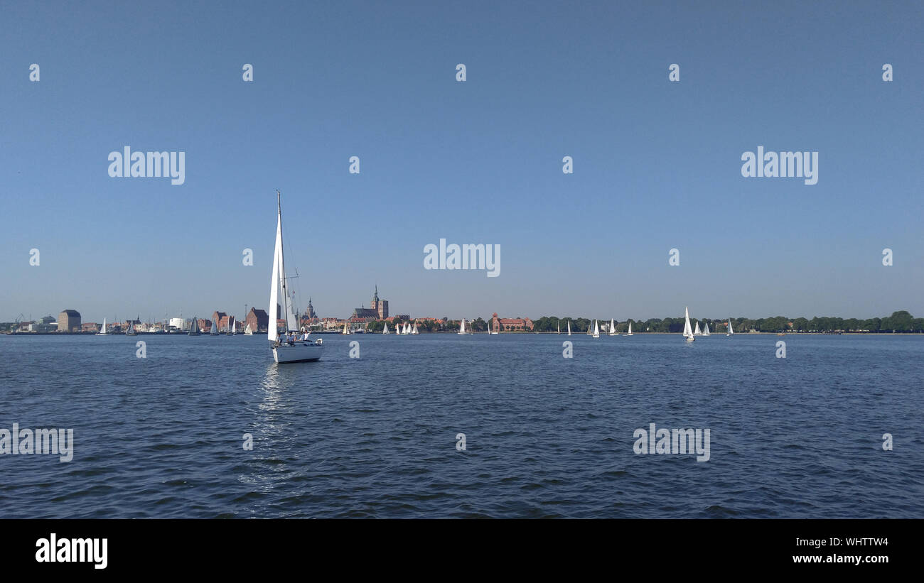 Sailboats Sailing In River Against Clear Sky Stock Photo