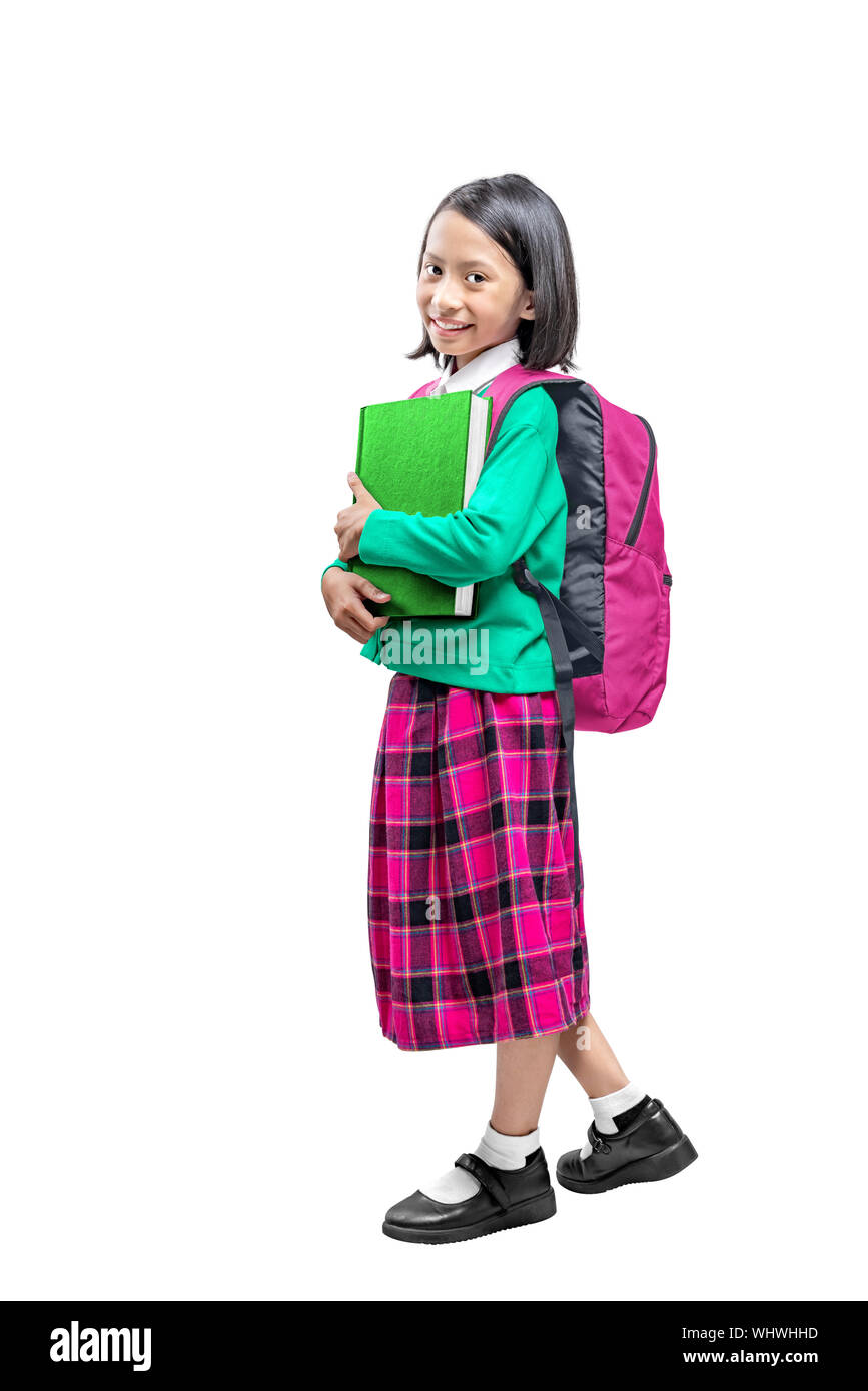 Asian cute girl with a backpack holding the book standing isolated over white background Stock Photo