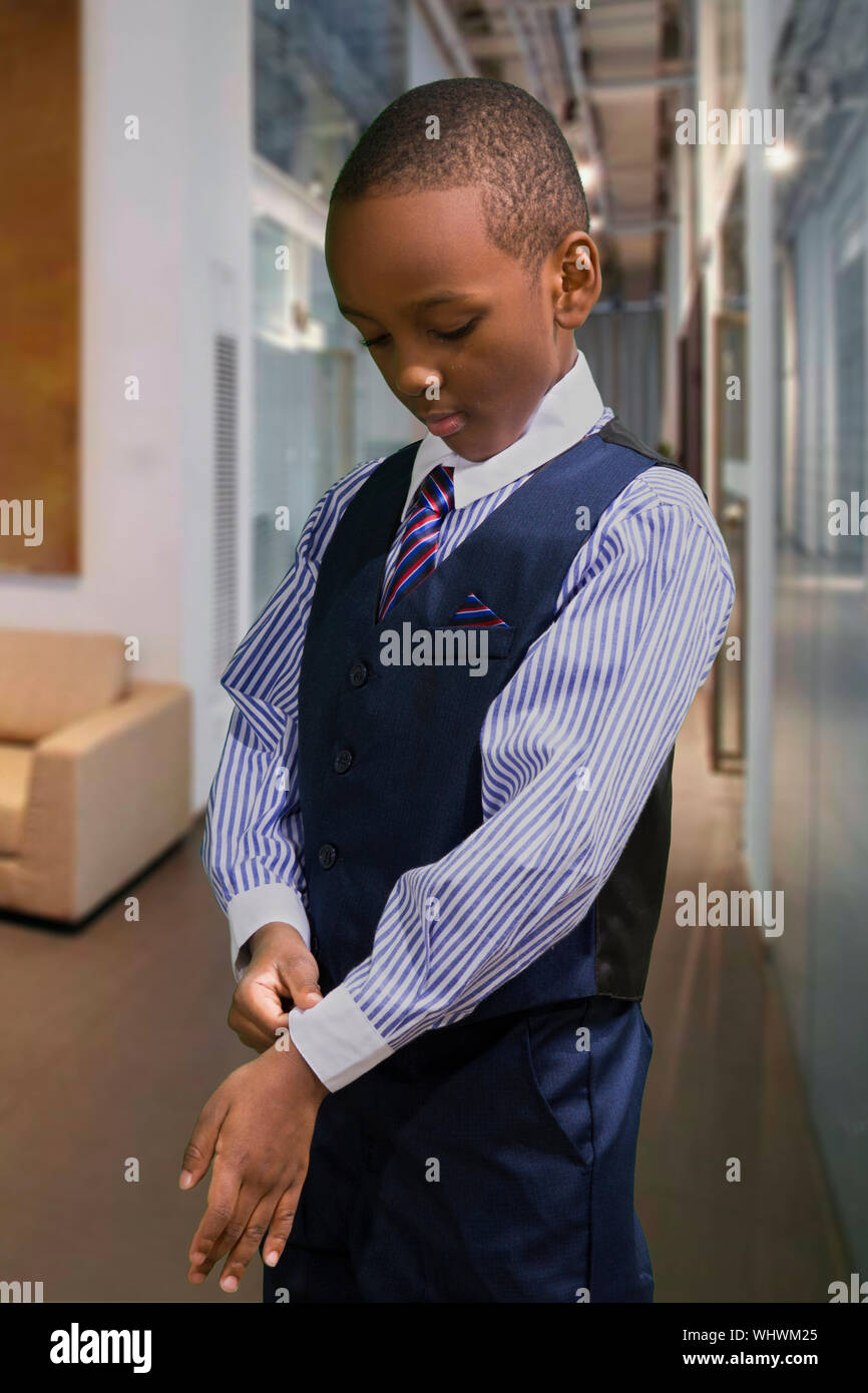 Boy In Full Suit Standing At Home Stock Photo