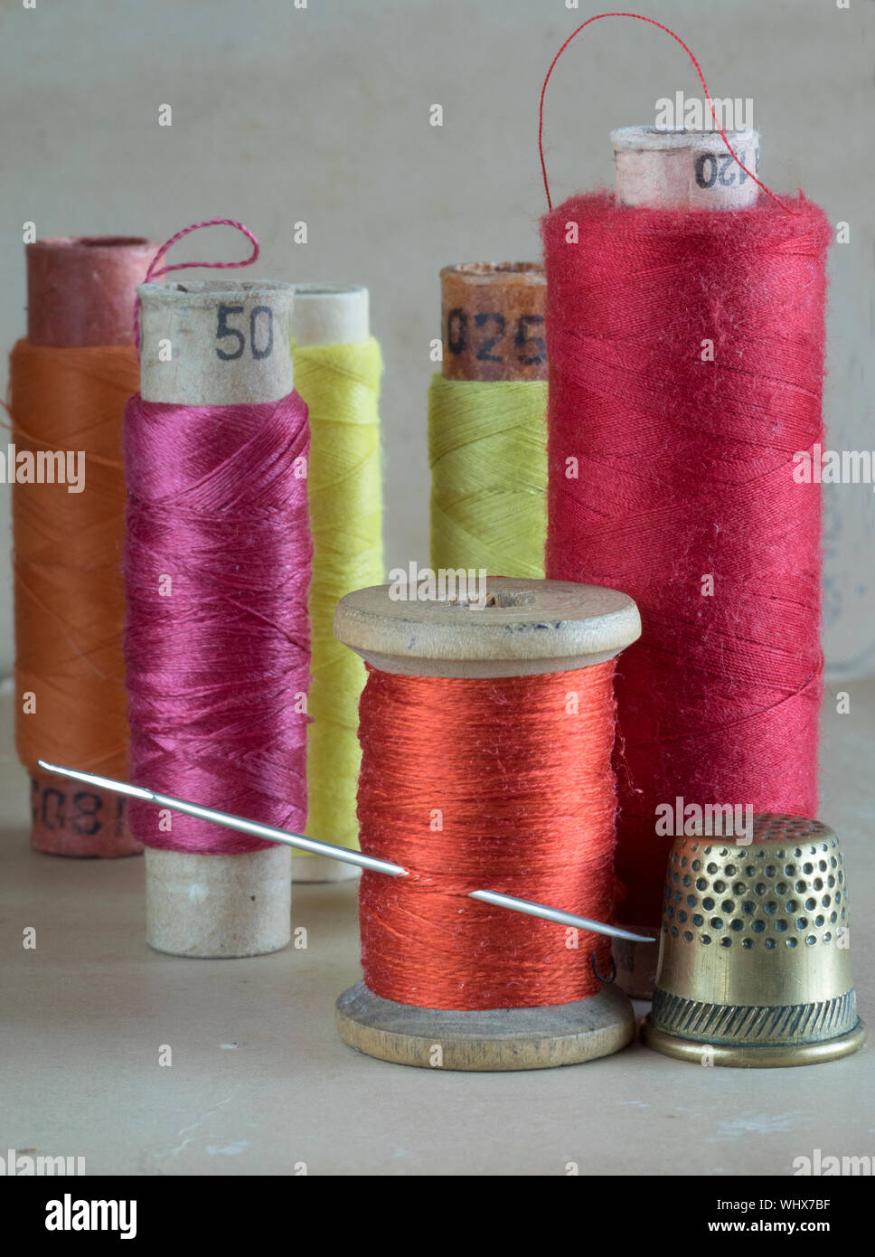 Colorful Threads With Spool And Thimble On Table Stock Photo