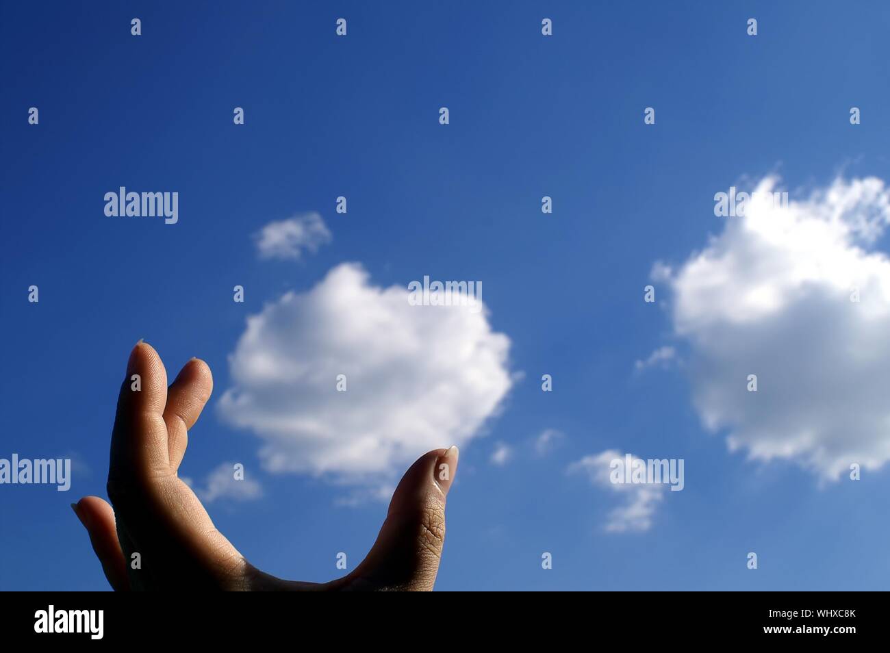 Optical Illusion Of Cropped Hand Holding Cloud Stock Photo