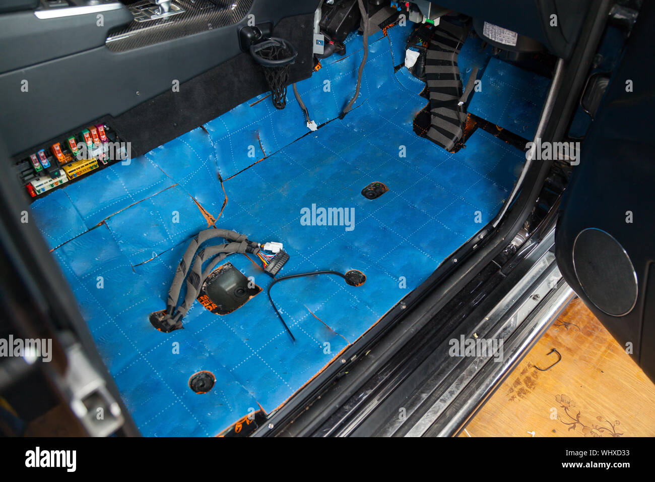 Tuning the car in a SUV body with three layers of noise insulation on the  floor. Sound and vibration isolation using blue soft and pimply material  wit Stock Photo - Alamy