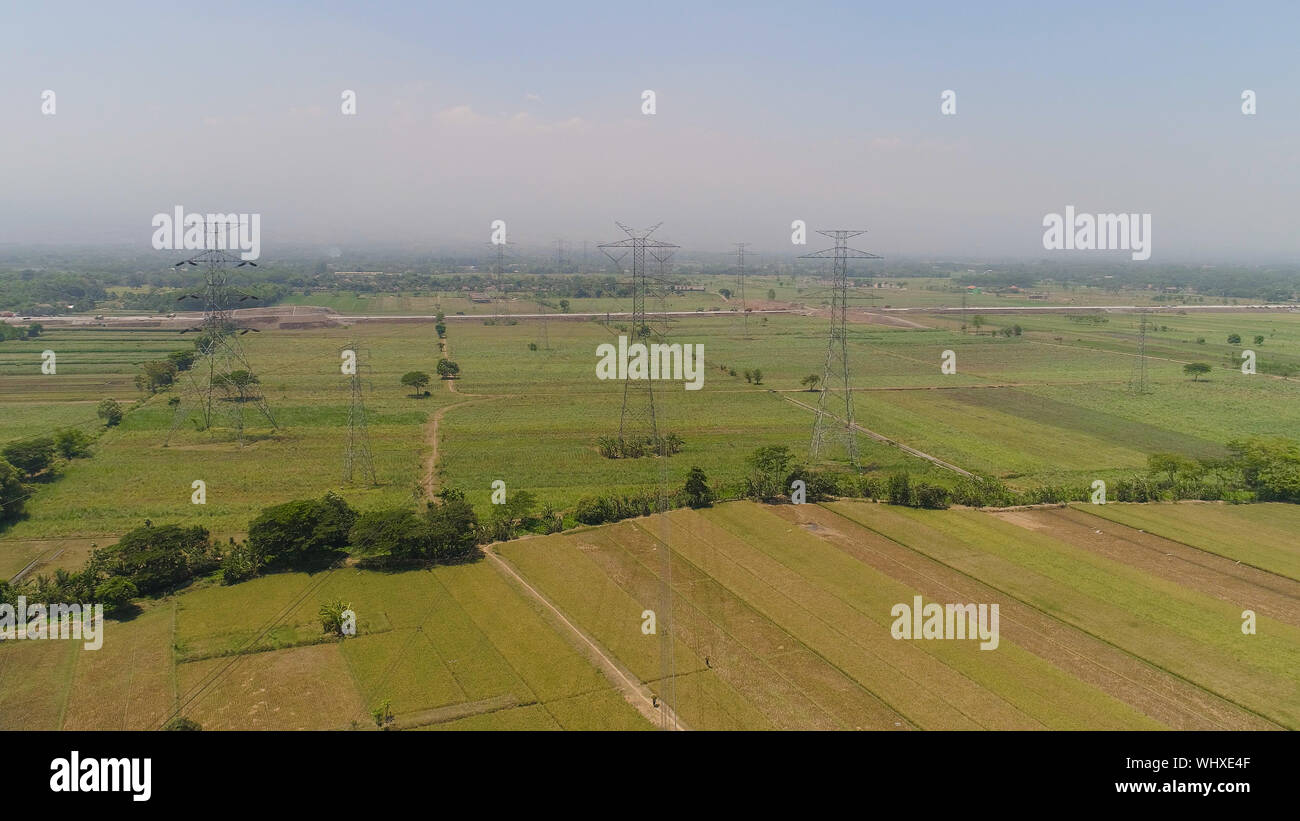Electricity pylons bearing power supply across agricultural land with ...