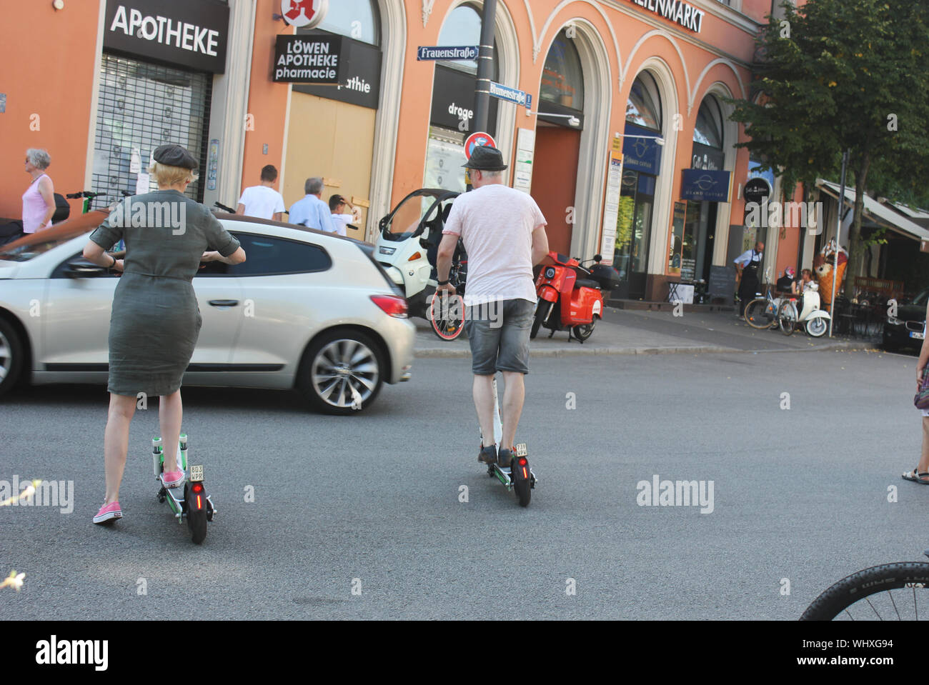 E mobility of silver ager, senior couple driving e-scooter. Stock Photo