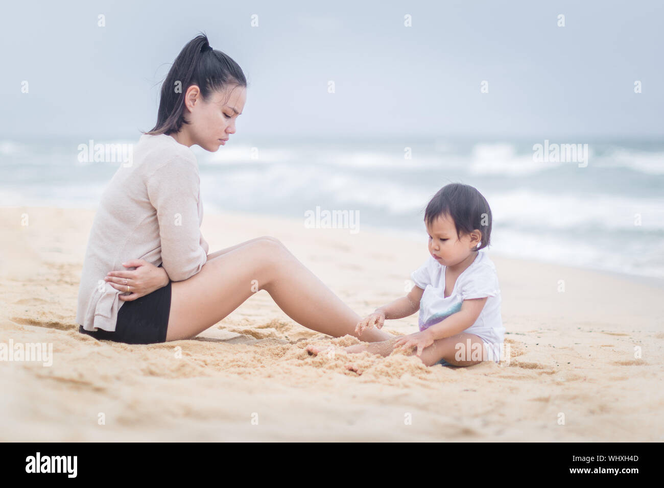 Stressed  and exhausted mother suffering from postpartum depression Stock Photo