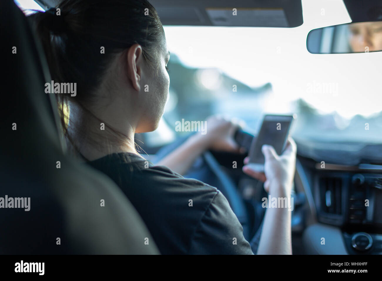 A person using a phone while driving car. Texting and driving Stock ...