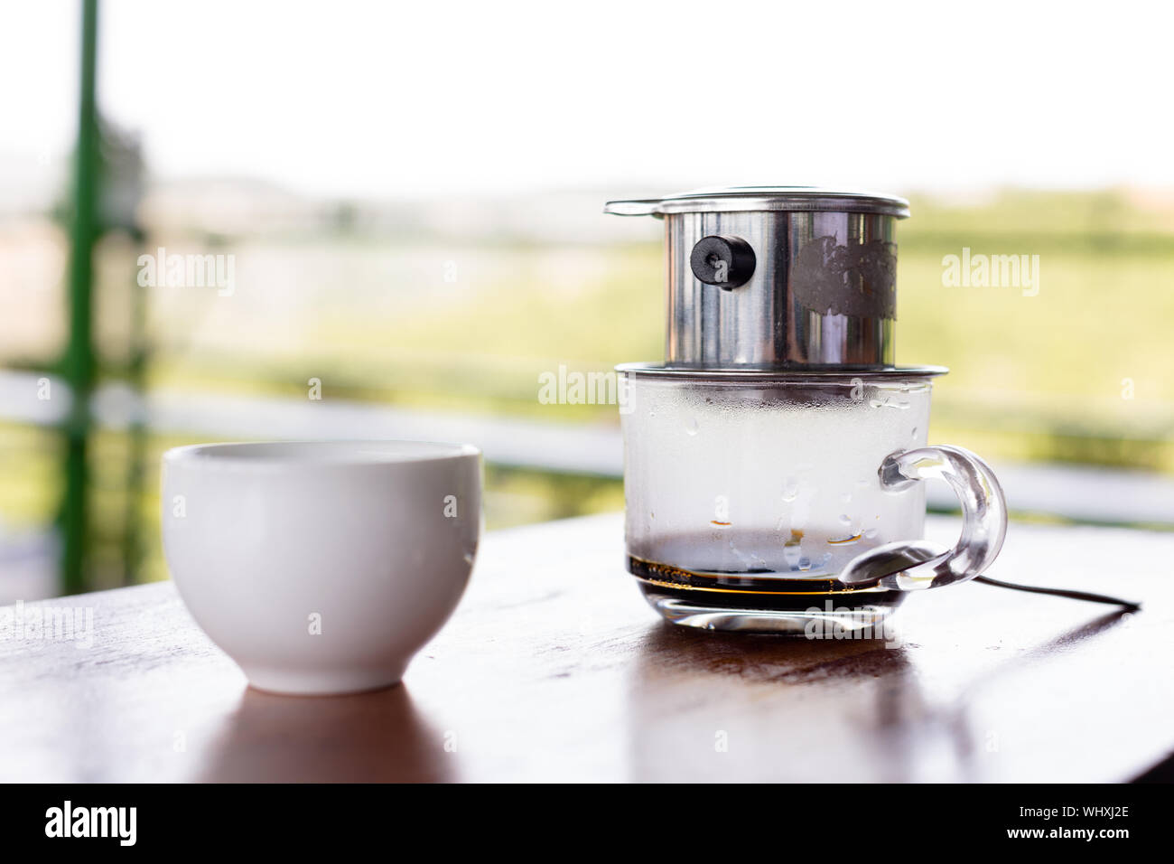Coffee drip filter at a cafe farm in Vietnam, green background Stock Photo
