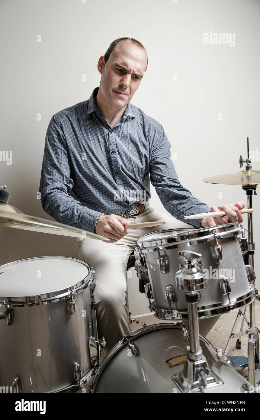 Serious Drummer Playing Drums Stock Photo