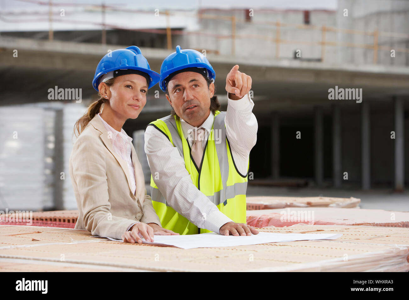 Architect and construction manager discussing plans at site Stock Photo ...